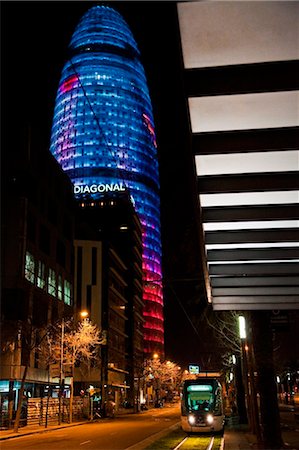 simsearch:862-06541761,k - Spain, Cataluna, Barcelona, El Clot, the multicoloured Torre Agbar by the architect Jean Nouvel, Ca L'Aranjo tram stop. Stock Photo - Rights-Managed, Code: 862-03737158