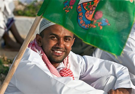 procession - Kenya. A jovial man relaxes before the start of the procession for Maulidi, the celebration of Prophet Mohammed s birthday. Stock Photo - Rights-Managed, Code: 862-03731556