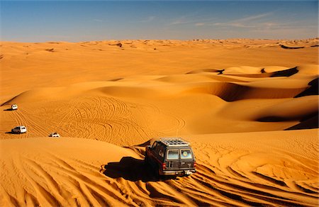 dune driving - Libya, Fezzan, Edeyen Ubari, near Ubari. Tourists' 4WD vehicles head into the seemingly endless dunes of the immense 'sand sea' of Edeyen Ubari. Stock Photo - Rights-Managed, Code: 862-03731775