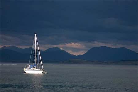 simsearch:862-03361556,k - Scotland, Isle of Mull. Sunlit yacht in the Sound of Mull against a dramtic stormy sky. Stock Photo - Rights-Managed, Code: 862-03732288