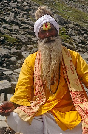 India, Himachal Pradesh, Chamba Valley, Lake Mani Mahesh. A Vaishnava (devotee of the Hindu god Vishnu) ascetic wears a tilak, or tilaka, on his forehead known specifically as an Urdhva Pundta Tilak comprising yellow sandalwood paste (chandan) and red saffron or tumeric paste (kumkum). It is often worn by followers of Swaminarayan. Stock Photo - Rights-Managed, Code: 862-03807594