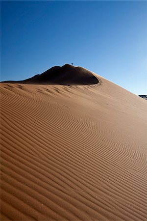 simsearch:862-03365353,k - Namibia, Sossusvlei. A tourist treks up one of the famous Sossusvlei sand dunes. Stock Photo - Rights-Managed, Code: 862-03808006