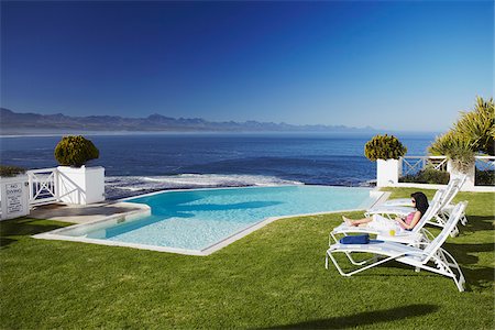 people relaxing in pool chairs - Woman relaxing poolside at Plettenberg Bay Hotel, Plettenberg Bay, Western Cape, South Africa Stock Photo - Rights-Managed, Code: 862-03808519