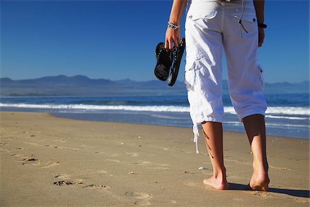 Woman standing on beach, Plettenberg Bay, Western Cape, South Africa Stock Photo - Rights-Managed, Code: 862-03808536