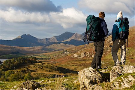 expedition - North Wales, Snowdonia.  A man and woman stop to look at their map whilst hiking in Snowdonia. Stock Photo - Rights-Managed, Code: 862-03808803