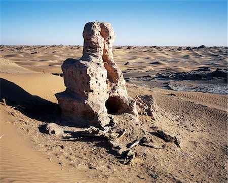 Remains of a Buddhist stupa, circa 3rd century Ad.Height 6 metres. Niya, north of Minfeng. This single ruined stupa of modest size stands at the centre of the site. It was built of mud-brick before 300AD and consists of a cylindrical dome on a square base. Stock Photo - Rights-Managed, Code: 862-03820248