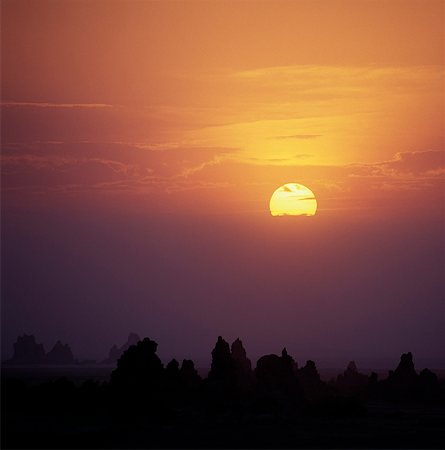 simsearch:862-03355195,k - Sunset over the fumaroles of Lake Abbe.Lake Abbe, on the border of Djibouti and Ethiopia, is the last in a line of alkaline lakes in which the Awash River dissipates. The jagged pinnacles and spires close to the lake were formed thousands of years ago when volcanic gases bubbled up through the bottom of an ancient lake that was 100 feet deeper than it is today. Stock Photo - Rights-Managed, Code: 862-03820287