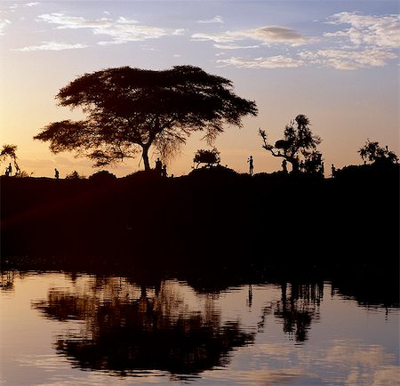 simsearch:862-03355195,k - Ethiopia, Southwest Ethiopia, Omo River.Sunset on the banks of the Omo River near a Dassanech village.Two dome shaped granaries are just visible in the trees. Stock Photo - Rights-Managed, Code: 862-03820343