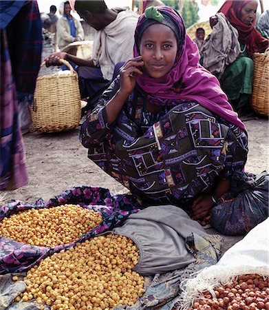 simsearch:862-06543210,k - A woman sells dried berries at Bati market.Situated on top of the western scarp of the Abyssinian Rift, Bati is the largest open air market in Ethiopia.Nomads and their camels trek long distances every week from the harsh low lying deserts to barter with Amhara and Oromo farmers living in the fertile highlands. Stock Photo - Rights-Managed, Code: 862-03820385