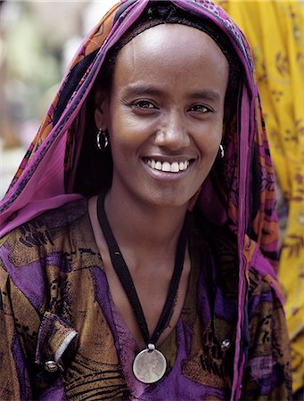 ethiopia and woman and one person - A woman in a colourful dress and matching headscarf wears round her neck a Maria Theresa thaler an old silver coin minted in Austria, which was widely used as currency in northern Ethiopia and Arabia until the end of World War II. Stock Photo - Rights-Managed, Code: 862-03820395