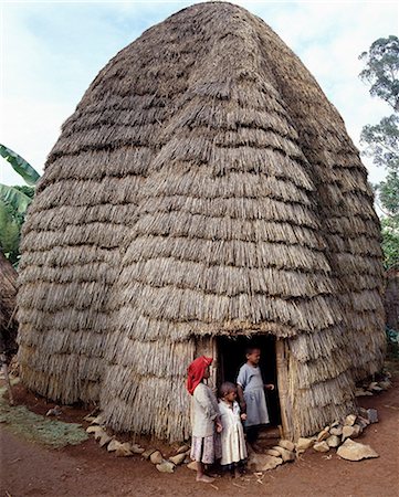 simsearch:862-03353978,k - The Dorze people living in highlands west of the Abyssinian Rift Valley have a unique style of building their homes. The twenty foot high bamboo frame is covered with the sheaths of bamboo stems or straw, and resembles a giant beehive.Doorways are set in a bulge of the house, which forms a reception area for guests.These remarkable houses can last for forty years or more. Stock Photo - Rights-Managed, Code: 862-03820414