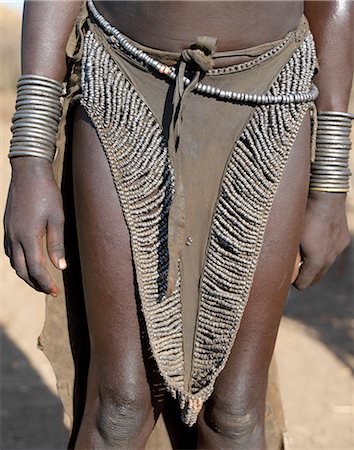 simsearch:862-03711116,k - The leather skirt of a Nyangatom girl richly decorated with metal beads.The Nyangatom are one of the largest tribes and arguably the most warlike people living along the Omo River in Southwest Ethiopia. Foto de stock - Con derechos protegidos, Código: 862-03820545