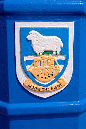 ram (animal) - The Falkand Island coat of arms painted on Port Stanley bin.Granted on September 29, 1948.The ship represents the Desire, the vessel in which the British sea captain, John Davis, is reputed to have discovered the Falkland Islands in 1592. Stock Photo - Rights-Managed, Code: 862-03820576
