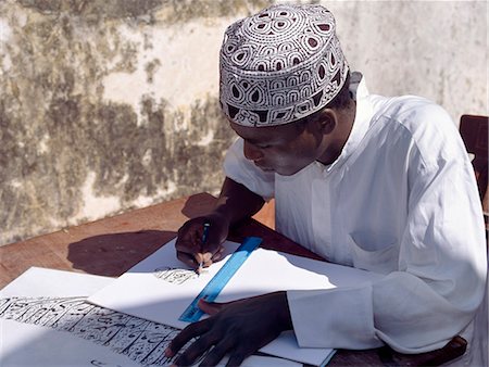 A Swahili student in Lamu practices Arabic calligraphy. Each year, students on the island participate in a competition to keep this art alive.Situated 150 miles north northeast of Mombasa, Lamu town dates from the 15th century AD. Stock Photo - Rights-Managed, Code: 862-03820715