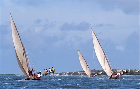 As a part of Maulidi, Lamu Islands celebrations to mark the birthday of the Prophet Mohamed, a keenly fought boat race is held. Maulidi is a joyous event in Lamu and attracts pilgrims from all over East Africa and sometimes farther afield. Stock Photo - Rights-Managed, Code: 862-03820726
