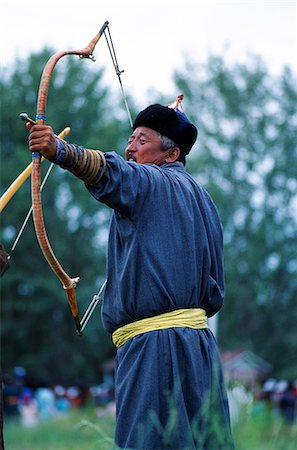 Mongolia, Khovd aimag, Naadem festival, archery Held annually in July, the great Naadem festival is a thrilling three day sporting event that has been happening for centuries. In Genghis Khans time it happened at different times of the year, particularly in summer. Since 1922, to mark the first aanniversary of the revolution it has been held annually from July 11-13. The festival highlights Mongol Stock Photo - Rights-Managed, Code: 862-03820857