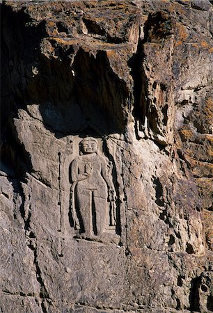 The Kargah Buddha, circa 7th or 8th century.Ten kilometres from Gilgit at Kargah, a massive figure of the Buddha has been carved onto the cliff face. Stock Photo - Rights-Managed, Code: 862-03820906