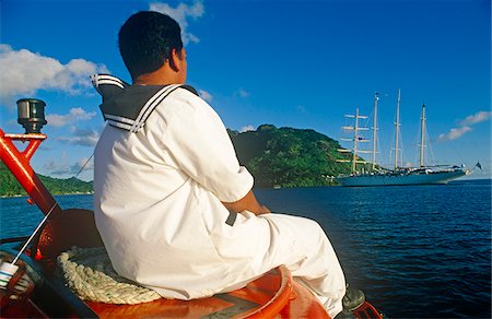 French Polynesia, Society Islands, Leeward Islands, Huahine Island, aka Matairea. A seaman returns to the Star Flyer, a barquentine opearted by Star Clippers, on a shuttle boat. Stock Photo - Rights-Managed, Code: 862-03887680