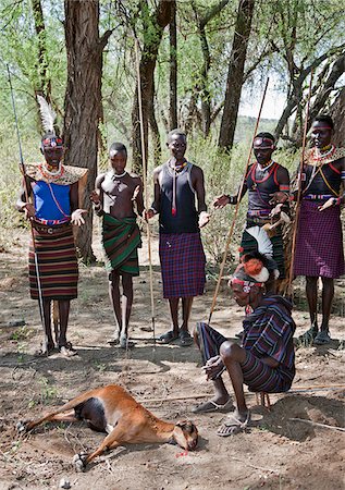 simsearch:862-03888708,k - In Pokot custom, when someone has a prolonged ailment, he may call his friends and relatives to chase away the disease.  A goat is speared whereupon people form a semicircle around the sick person to pray and chant for his good health. Stock Photo - Rights-Managed, Code: 862-03888706