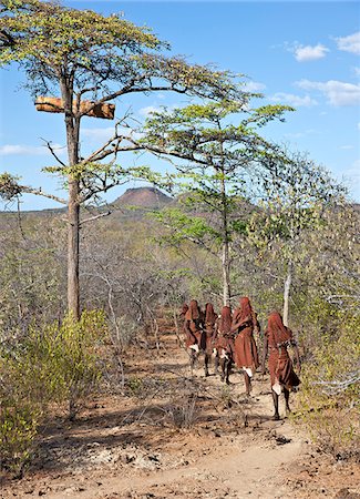 simsearch:862-03888708,k - After 2-3 months seclusion, Pokot initiates leave their camp in single file to celebrate Ngetunogh.  They must wear goatskins, conceal their faces with masks made from wild sisal (sansevieria) and carry bows with blunt arrows until this ceremony is over. Stock Photo - Rights-Managed, Code: 862-03888757