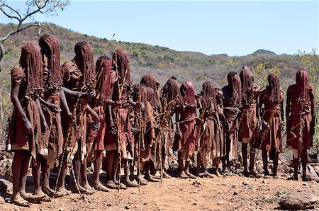 For two to three months after their circumcision, Pokot boys sing and dance in a special seclusion camp while undergoing instruction from tribal elders.  During this time, they must wear goatskins, conceal their faces with masks made from wild sisal (sansevieria) and carry bows with blunt arrows. Stock Photo - Rights-Managed, Code: 862-03888753