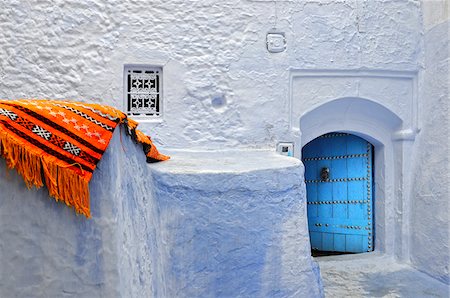 Orange blanket in the bluish Chefchaouen medina. Morocco Stock Photo - Rights-Managed, Code: 862-03888900