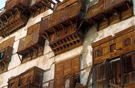 Saudi Arabia, Makkah, Jeddah. Al-Balad, the historic heart of Jeddah, still contains some 19th-century buildings with their distinctive mashrabiyas (Arab oriel windows) - wooden latticework screening windows and supporting small projecting balconies. Stock Photo - Rights-Managed, Code: 862-03889546