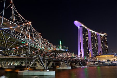 singapore - Singapore, Singapore, Marina Bay.  The Helix Bridge and Marina Bay Sands Singapore.  The  hotel complex includes a casino, shopping mall and the ArtScience Museum. Stock Photo - Rights-Managed, Code: 862-03889596