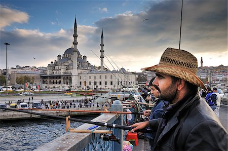 Fishermen on the Galata bridge. On the background, the Yeni Camii mosque. Istanbul, Turkey Stock Photo - Rights-Managed, Code: 862-03889939