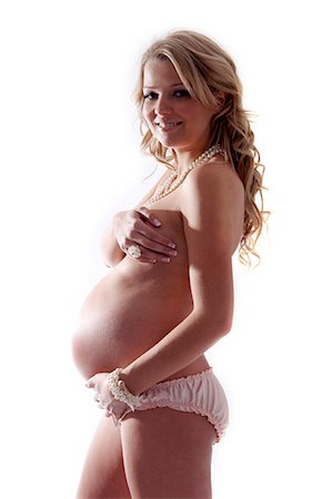 pregnancy nude - Pregnant woman with hand on stomach Stock Photo - Rights-Managed, Code: 877-06834117