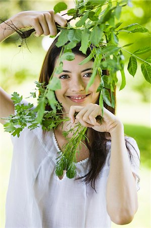 simsearch:877-06834306,k - Young woman holding leaves Stock Photo - Rights-Managed, Code: 877-06834131