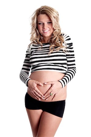 simsearch:877-06834121,k - Pregnant woman with hands on stomach in heart shape Stock Photo - Rights-Managed, Code: 877-06834276