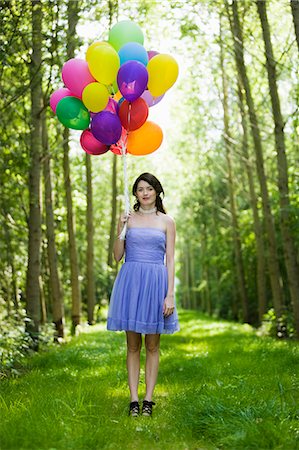 simsearch:877-06834306,k - Young woman holding bunch of balloons Stock Photo - Rights-Managed, Code: 877-06834295
