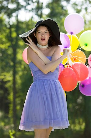 simsearch:877-06834306,k - Young woman holding bunch of balloons Stock Photo - Rights-Managed, Code: 877-06834293