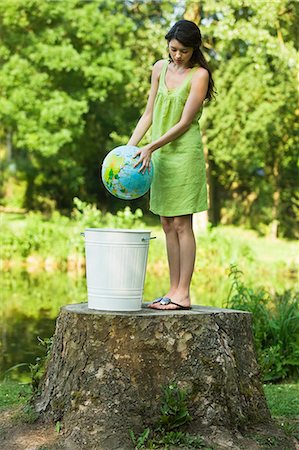 simsearch:877-06834306,k - Young woman throwing globe into dustbin Stock Photo - Rights-Managed, Code: 877-06834362