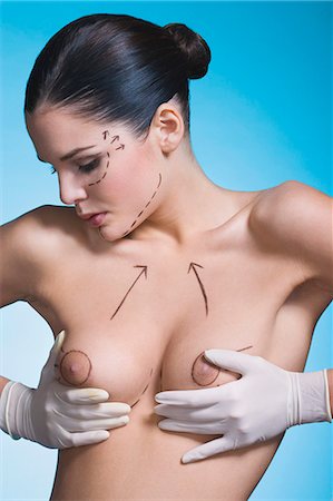 palpate - Young woman with presurgical markings on breast and face Stock Photo - Rights-Managed, Code: 877-06836307