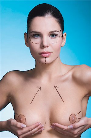 palpate - Young woman with presurgical markings on breast and face Stock Photo - Rights-Managed, Code: 877-06836303