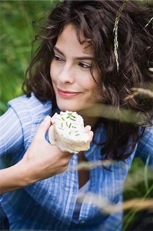 simsearch:877-06832318,k - Portrait of young woman eating cheese toast Stock Photo - Rights-Managed, Code: 877-06836407