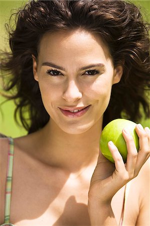 Young woman holding an apple Stock Photo - Rights-Managed, Code: 877-06832179