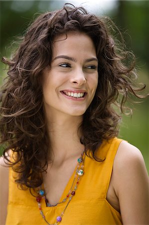 emotional woman looking away - Portrait of a young woman smiling Stock Photo - Rights-Managed, Code: 877-06832195