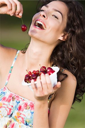 simsearch:877-06832318,k - Young woman eating cherries Stock Photo - Rights-Managed, Code: 877-06832228
