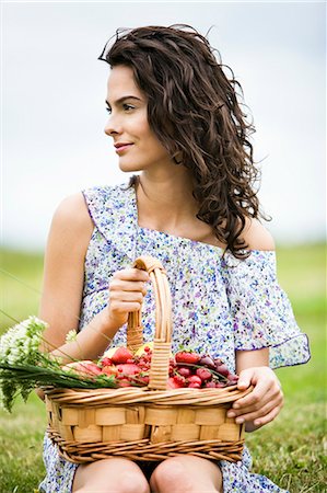 simsearch:877-06832290,k - Young woman with a basket full of fruits Stock Photo - Rights-Managed, Code: 877-06832268