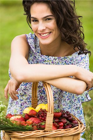 simsearch:877-06832290,k - Young woman with a basket full of fruits Stock Photo - Rights-Managed, Code: 877-06832270