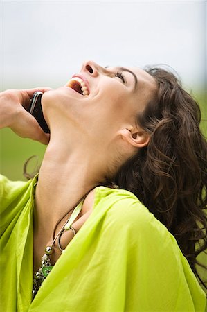simsearch:877-06832318,k - Young woman using her cell, laughing, oudoors Stock Photo - Rights-Managed, Code: 877-06832286