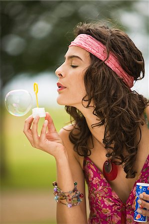simsearch:877-06832290,k - Young woman blowing soap bubbles Stock Photo - Rights-Managed, Code: 877-06832292