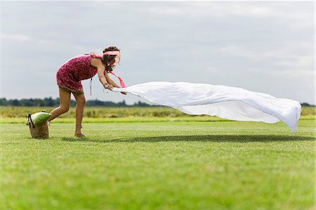 simsearch:877-06832290,k - Young woman setting a sheet on the grass, oudoors Stock Photo - Rights-Managed, Code: 877-06832307