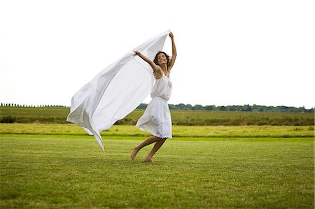 simsearch:877-06832290,k - Young woman running with white sheet, oudoors Stock Photo - Rights-Managed, Code: 877-06832352