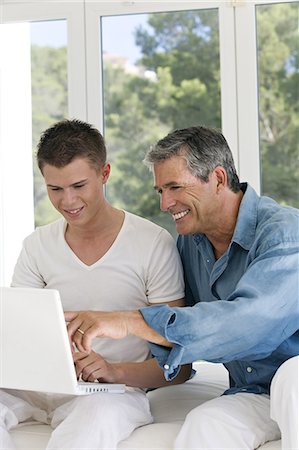 Senior man an young man at home, using laptop Stock Photo - Rights-Managed, Code: 877-06832421