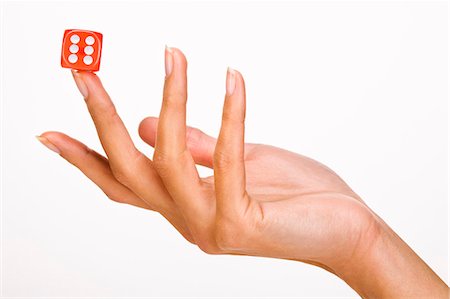 Woman's hand holding one dice Stock Photo - Rights-Managed, Code: 877-06832637