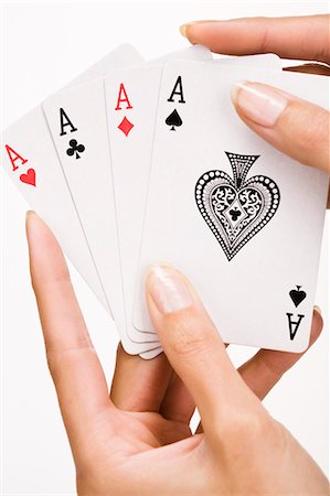 Woman's hand holding four playing cards (ace) Stock Photo - Rights-Managed, Code: 877-06832652